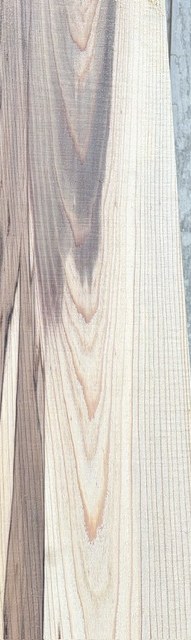 Fresh-sawn cypress board with dark streaks and tight grain